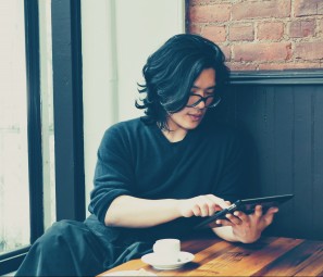 Young man using digital tablet in cafe