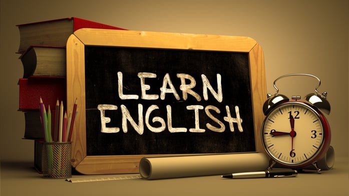 Learn English Concept Hand Drawn on Chalkboard. Blurred Background. Toned Image..jpeg