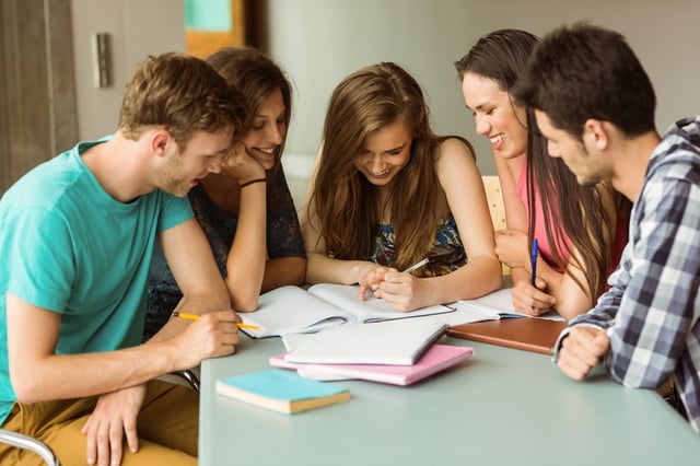 Smiling friends sitting studying together after school.jpeg