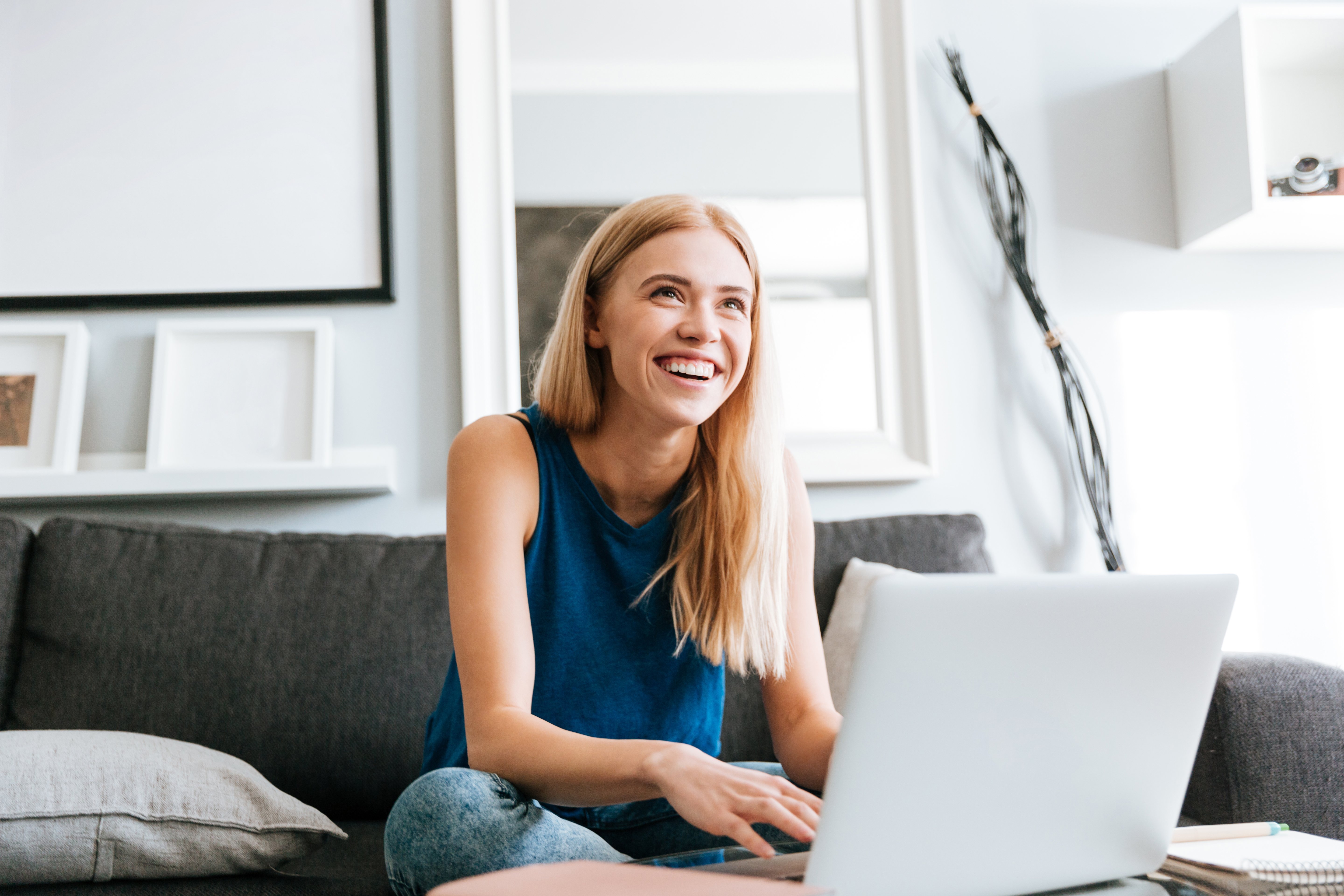 cheerful-woman-using-laptop-and-laughing-at-home