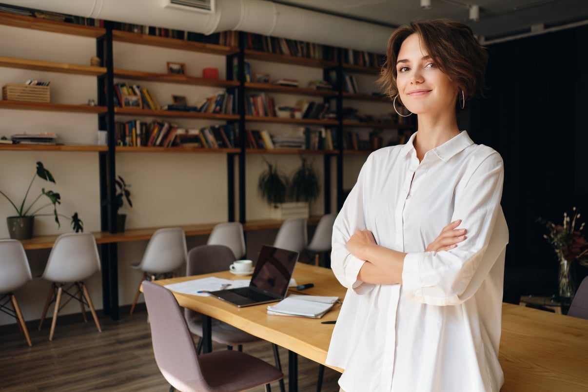 young-attractive-woman-white-shirt-dreamily-looking-camera-with-desk-background-modern-office